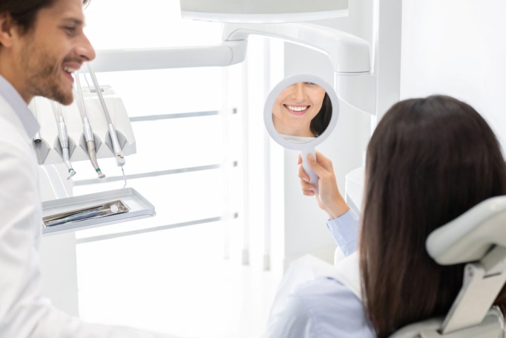 satisfied patient with a handsome dentist beside